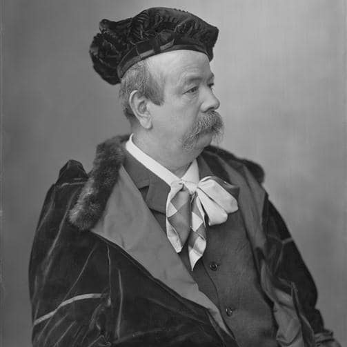 Monochrome photo of Charles Worth, wearing a beret, cravat and coat, side profile